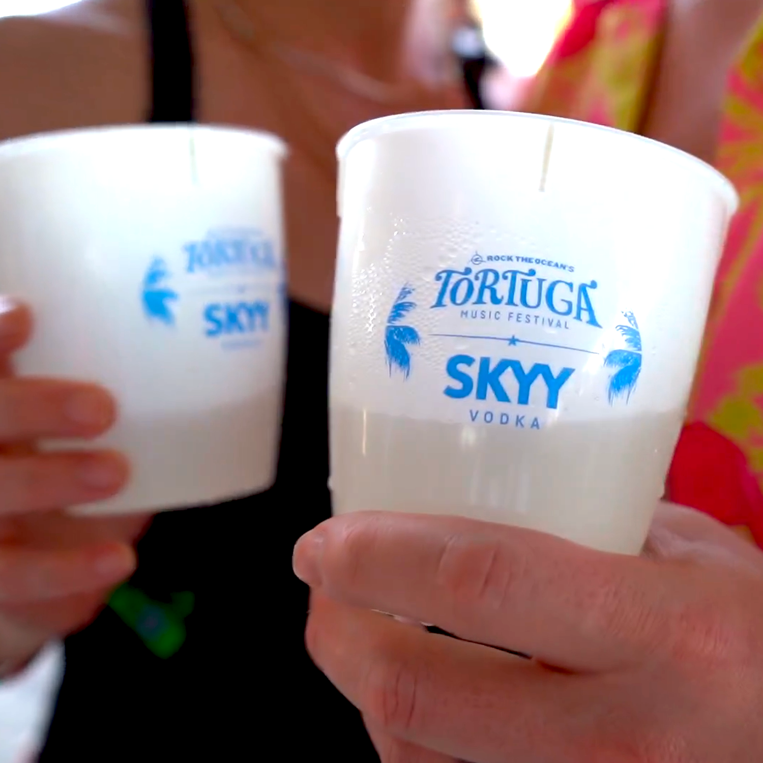 Attendees of Rock the Ocean's Tortuga Music Festival using Better for All cups that feature the festival branding. 